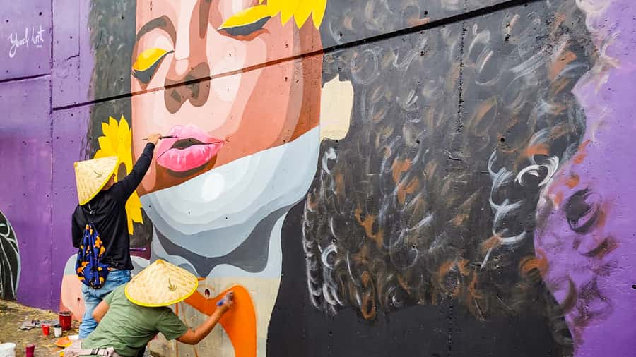 A painted portrait covering a hillside house wall in Comuna 13, Medellin