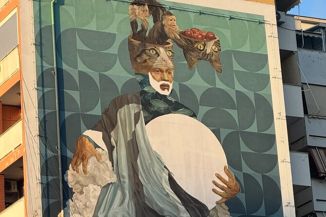 Tirana Mural Bike Tour: Street Art, Culture & Photography Stops - DOG and Mots bring surreal color to a quiet corner
